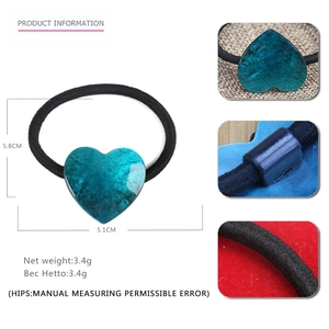 Detailed view of teal glitter acetate heart hair tie showing size and weight info