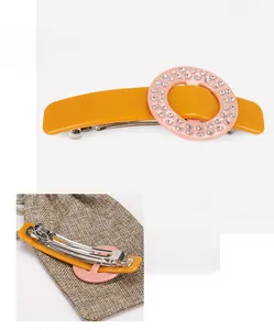 Detailed size view of orange cellulose acetate hair clip with pink rhinestone accent