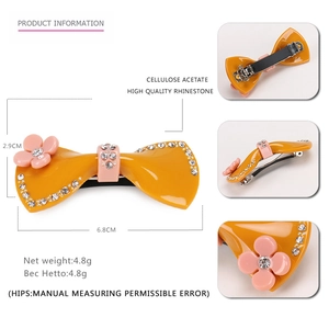Barrette nœud en acétate jaune avec fleur en strass rose et fermoir à ressort robuste