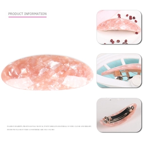 Detail of pink marble acetate hair clip showing the metal spring clamp and various colors