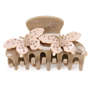 Detailed close-up of a khaki bow hair claw clip with pink butterflies and pearls