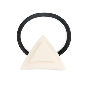 Close-up of cream acetate double triangle decorative piece on black elastic hair tie