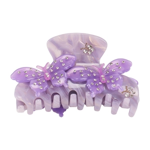 Detail of purple acetate hair claw clip with butterfly design and sparkling rhinestones