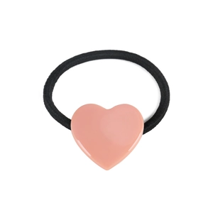 Close-up of pink heart-shaped resin charm on black elastic hair tie for ponytail