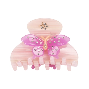 Macro view of acetate bow hair claw clip with pink butterfly and sparkling crystals