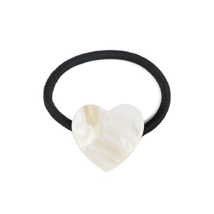 Detail of high-elasticity black hair tie featuring a marble-textured acetate heart charm