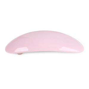 Detail of glossy light pink arched hair clip with smooth finish and metal spring structure