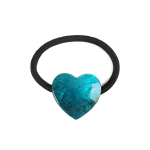 Macro detail of the turquoise marble heart hair tie with golden foil inclusions