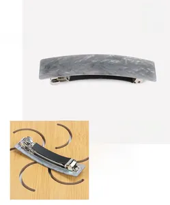 Macro detail of 8.3x2.0cm grey marble acetate hair clip with silver spring mechanism