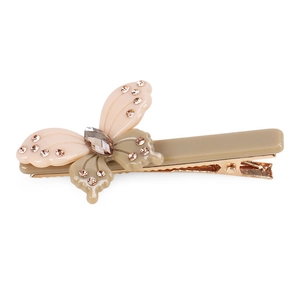Detailed close-up of a butterfly hairpin with beige resin wings and small crystals