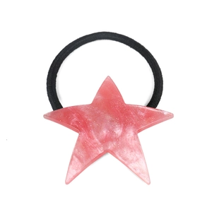 Close-up of pink marble acrylic star hair tie with glitter details and black elastic