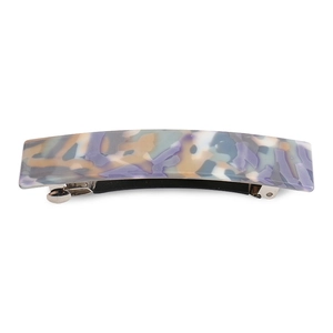 Detailed close-up of a marbled purple and blue acrylic hair clip with metal spring