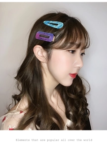 Detail showing blue marble teardrop hair clip and purple hollow rectangular hair clip set