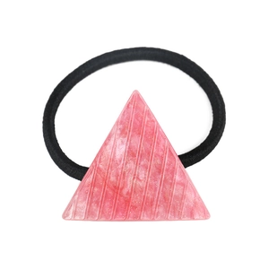 Detail of pink triangle acetate hair tie with glitter accents and elastic band