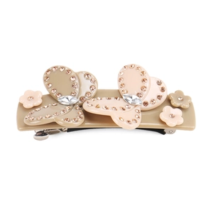 Close-up of acetic acid bow hair clip with sparkling crystals and floral details