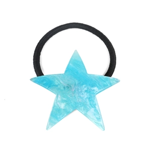 Detailed macro view of the blue marble star charm with glitters on a black hair tie