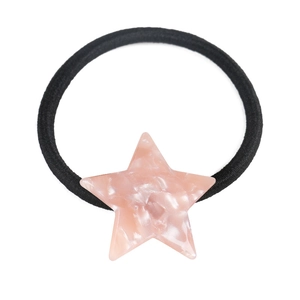 Detail of a black elastic hair tie featuring a pink marble textured star ornament