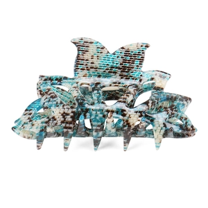 Macro detail of tortoiseshell acetate hair claw clip with blue and brown plaid pattern