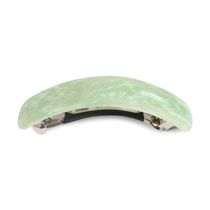 Detail of light green marble texture spring hair clip with subtle glitter finish on white background