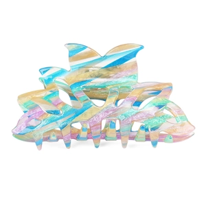 Detail of large acetate hair claw clip featuring colorful marble striped pattern textures
