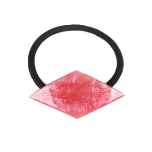 Detail of pink geometric resin hair tie with marble texture on elastic rope