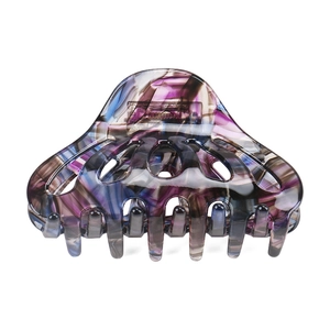 Macro detail of the glossy marble texture and sturdy spring on the purple hair claw clip