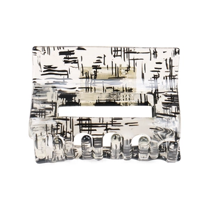 Close-up of translucent square hair claw clip with black abstract artistic patterns