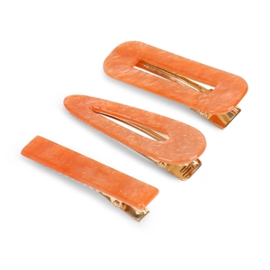 Three-piece acetate hair clip set with orange marble texture and gold metal base