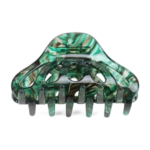 Green marbled acetate hair claw clip with cutout design for elegant women's hairstyling