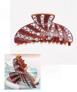 Detailed macro view of wine red acetate hair claw clip decorated with sparkling rhinestones