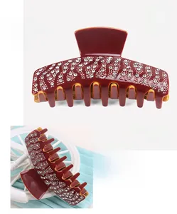 Macro detail of luxury burgundy acetate hair claw clip with sparkling rhinestones 9.1cm