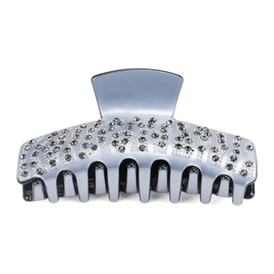 Detail view of large silver hair claw clip with rhinestones and dense teeth for long hair