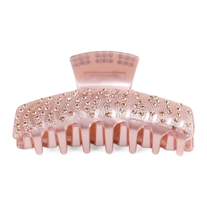 Detailed close-up of champagne rhinestones on a large peach pink acetate hair claw clip