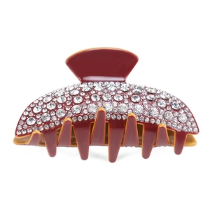 Close-up of red hair claw clip with sparkling rhinestones on high quality resin