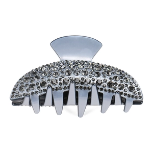 Detail shot of large rhinestone hair claw with grey crystal accents and acetate resin base