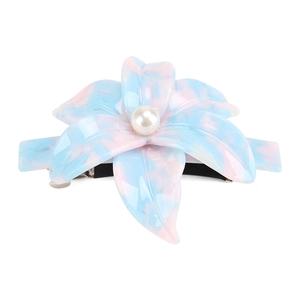 Detail of lily-shaped acetate hair clip with pink marble pattern and pearl center