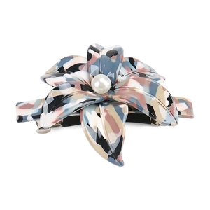 Detail view of acetate floral spring clip with marble texture and pearl center