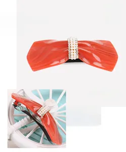 Red acetate bow hair clip detail with inlaid pearls and sparkling rhinestones
