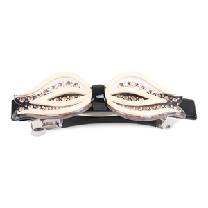 Barrette en acétate avec strass et motif floral en forme d'aile, coloris noir et crème chic