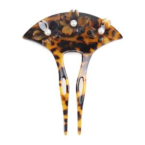 Detail showing acetate hair pin with fan shape, three cherry blossoms and pearl accents