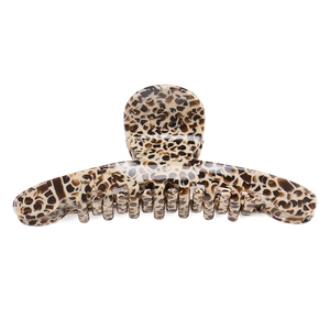Detailed close-up of large acetate shark hair claw clip with brown leopard tortoise pattern