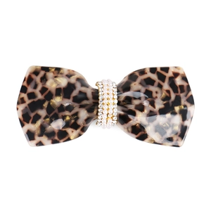 Detail of tortoise shell acetate bow hair clip with pearl and rhinestone embellishments