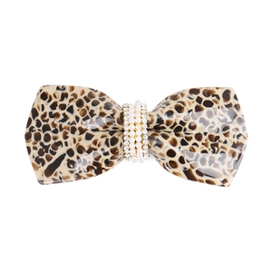 Detail of tortoiseshell acetate bow hair clip with faux pearls and sparkling rhinestones