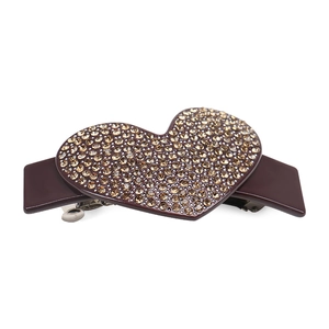 Detailed close-up of heart-shaped hair clip with sparkling rhinestones and metal spring clip
