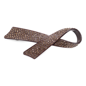 Détail du nœud barrette avec strass ambrés et finition en acétate poli élégant