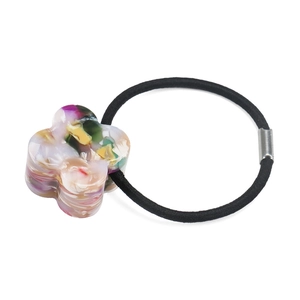 Close-up of elastic hair tie with marble texture resin flower and silver metal buckle