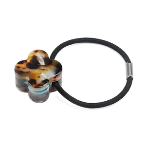 Detail of clover hair tie with tortoiseshell resin charm and elastic band for women