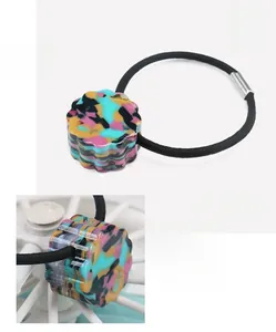 Detail of colorful marble acetate hair tie with dimension specs and gear design