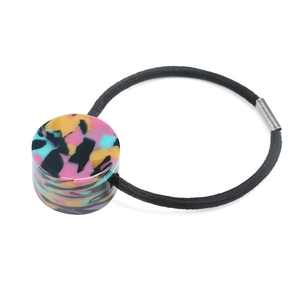 Detail showing marble texture acetate cylinder decoration on high elastic black hair tie