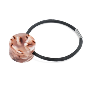 Detail of high-elastic hair tie with tortoiseshell resin cylinder and metal fastener